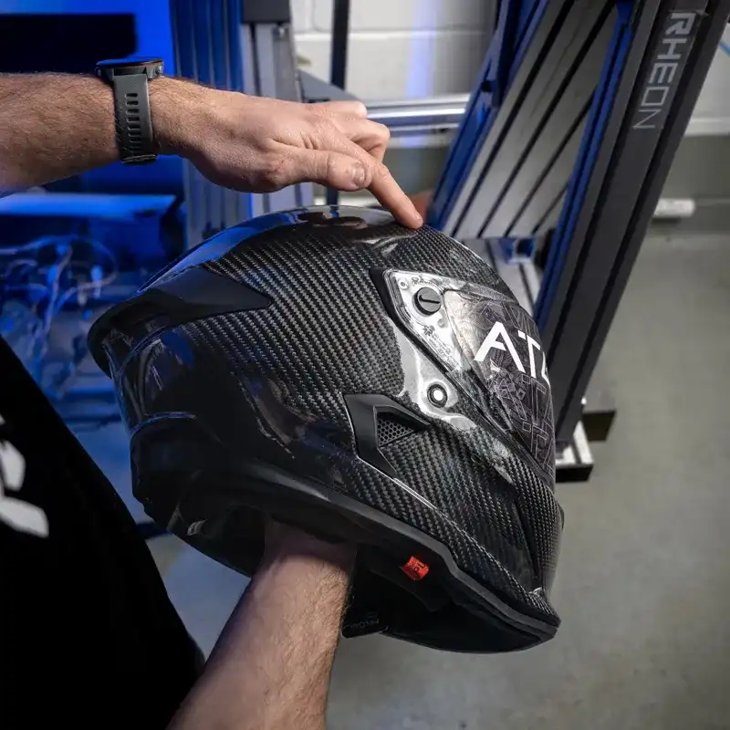 A Rheon™ engineer holding a Ruroc helmet
